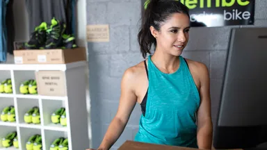 Woman using fitness software on her desktop computer